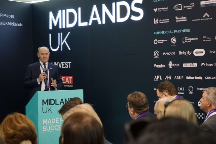 Sir John Peace speaking at an event inside the Midlands UK Pavillion