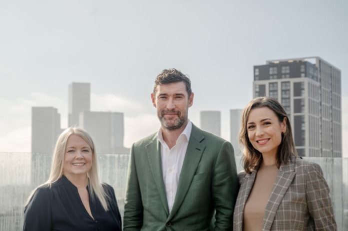 From l to r Hilary Pascoe and Dan Booth from Leonard Curtis with Laura Percy from Muse on top of the Eden building in Manchester (1)